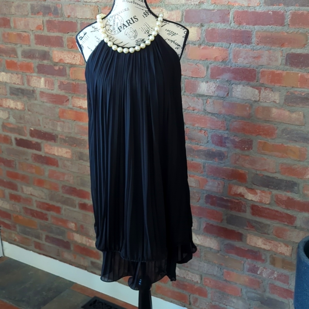 Little black dress with large pearlized straps.